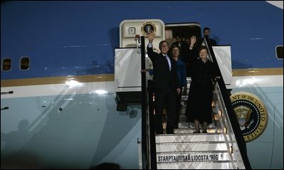 Waving to the crowd, President and Mrs. Bush and Latvia's President Vaira Vike-Freiberga deplane Air Force One Friday night, May 6, 2005, after the Bushes arrived in Riga, Latvia for the first of four European stops.