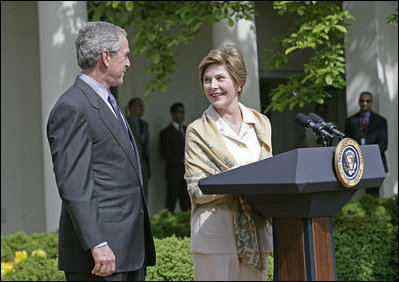 Laura Bush looks over to President Bush during a Rose Garden announcement honoring the 2005 Preserve America Presidential Awards Winners Monday, May 2, 2005. "These awards recognize collaborative efforts to protect and enhance our nation's cultural and historical heritage," said Mrs. Bush in her remarks.