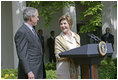 Laura Bush looks over to President Bush during a Rose Garden announcement honoring the 2005 Preserve America Presidential Awards Winners Monday, May 2, 2005. "These awards recognize collaborative efforts to protect and enhance our nation's cultural and historical heritage," said Mrs. Bush in her remarks.