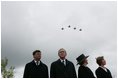 Jan Peter Balkenende, Prime Minister of The Netherlands, left, President George W. Bush, Queen Beatrix of The Netherlands, and Mrs. Laura Bush stand on stage Sunday, May 8, 2005, at the Netherlands American Cemetery in Margraten, as a flyover marks the remembrance of those who served in World War II.