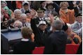President George W. Bush and Mrs. Bush wave to a crowd at the American Cemetery in Margraten, Netherlands Sunday, May 8, 2005, honoring those who served in World War II 60 years ago.