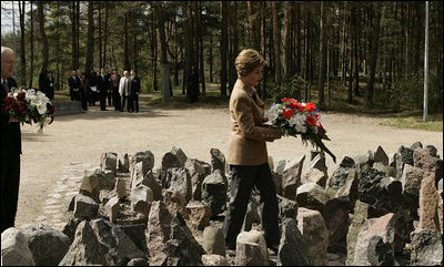 Laura Bush lays flowers at the Rumbula Holocaust Memorial in Riga, Latvia, Saturday, May 7, 2005.