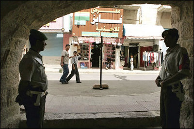 Jordanians guard the Haret Jdouna restaurant in Madaba, Jordan, as Laura Bush has lunch with Jordanian women leaders to discuss women’s rights Saturday, May 21, 2005.