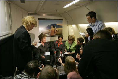 Laura Bush talks with members of the press pool aboard Air Force One during a flight to Amman, Jordan, Thursday, May 19, 2005.