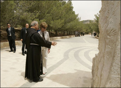 Father Michele Piccirillo, head of the Franciscan Archeology Society, discusses a monument with Laura Bush during her tour of Mount Nebo in Jordan Saturday, May 21, 2005.