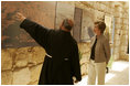 Father Michele Piccirillo, head of the Franciscan Archeology Society, gives Laura Bush a tour of the Interpretative Center at Mount Nebo in Jordan Saturday, May 21, 2005. Mount Nebo is the holy site where Moses is believed to have died.
