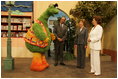 Laura Bush and Suzanne Mubarak, wife of Egyptian President Hosni Mubarak, right, meet children's television character Nimnim, left, and Amr Koura, CEO of Alkarma Endutainment, before taking a segment for the "Alam Simsim" show in Cairo, Egypt, May 23, 2005. The program offers educational curriculum in an inventive way that puts fun into learning for Egyptian children.