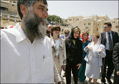 Laura Bush departs the Western Wall after inserting a prayer in the wall and taking a tour of the model of Mount Moriah Sunday, May 22, 2005.