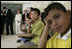 Laura Bush joins students in watching a kids educational program at the Discovery School of Swaifiyeh Secondary School in Amman, Jordan, Sunday, May 22, 2005.