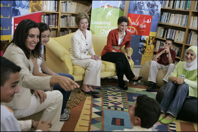 Soraya Sulti, regional director of INJAZ, left, and students at the Discovery School of Swaifiyeh Secondary School in Amman, Jordan, share their experiences with INJAZ with Laura Bush and Queen Raina, center right, May 22, 2005. INJAZ promotes entrepreneurship and community leadership among Jordan's youth by teaching entrepreneurship, business ethics, leadership and community involvement.