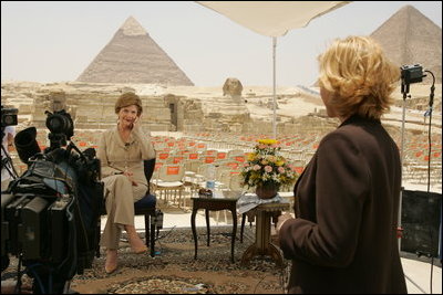 Press Secretary Susan Whitson talks with Laura Bush between television interviews in front of the Giza Pyramids in Giza, Egypt, Monday, May 23, 2005.