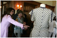 Mrs. Laura Bush is shown a dress worn by former Argentine First Lady Eva Peron as the U.S. First Lady participated in a luncheon Saturday, Nov. 5, 2005, in Mar del Plata that included a display of important Argentine women.