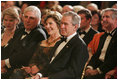 President George W. Bush and Mrs. Laura Bush listen to the evening's entertainment at the White House, Thursday, Nov. 10, 2005, following the dinner celebrating the 40th Anniversary of the National Endowment for the Arts and the National Endowment for the Humanities.