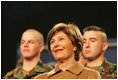 Mrs. Laura Bush smiles as she listens to the President’s introduction Monday, Nov. 14, 2005, at Elmendorf Air Force Base in Anchorage, Alaska, where he delivered remarks on the War on Terror to the troops.