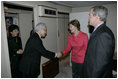 As President Bush looks on, Mrs. Laura Bush shakes hands with Japanese Ambassador to the United States Ryozo Kato and his wife, Hanayo, as the couple greeted the President and First Lady upon their arrival Tuesday, Nov. 15, 2005, to Osaka International Airport.