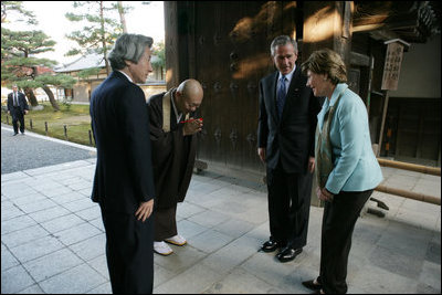 President and Mrs. Bush are greeted by the Reverend Raitei Arima, Chief Priest at the Golden Pavilion Kinkakuji Temple, and Japan’s Prime Minister Junichiro Koizumi, at the doors of the temple Wednesday, Nov. 16, 2005, in Kyoto.