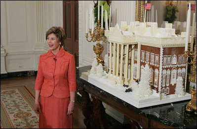 Laura Bush stands before the White House gingerbread house , Wednesday, Nov. 30, 2005, as she answers questions during the press preview of the White House Christmas decorations.