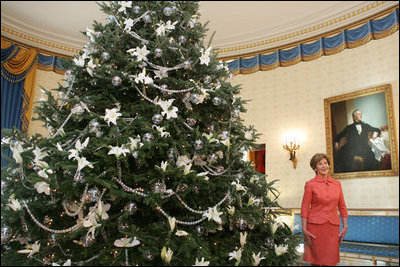 Laura Bush stands next to the Blue Room Christmas tree, Wednesday, Nov. 30, 2005, as she answers questions during the press preview of the White House Christmas decorations.