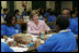 Laura Bush talks with students Wednesday, Nov. 30, 2005 during a visit to the Church of the Epiphany in Washington, as part of her Helping America's Youth initiative, where the students, part of the Youth Service Learning Project, were preparing sandwiches to feed the homeless.