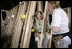 Laura Bush helps push a support wall into place, Tuesday, Oct. 11, 2005, while visiting a Habitat for Humanity building site in Covington, La., where homes are being built for victims of Hurricane Katrina.