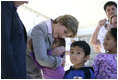 Laura Bush gives a hug to a student at Delisle Elementary School in Pass Christian, Miss., Tuesday, Oct. 11, 2005, as the school reopened for the first time since the area was struck by Hurricane Katrina.
