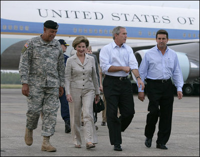 President George W. Bush and Laura Bush walk with Lt. General Russel Honore, left, and Plaquemines Parish president Benny Rousselle, right, upon their arrival Monday, Oct. 10, 2005 at the U.S. Naval Air Station, Joint Reserve Base in New Orleans, La.