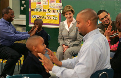 Laura Bush watches fathers play a game with their children in the R.E.A.D. to Kids Training Program at J.S. Chick Elementary School in Kansas City, Mo., Tuesday, October 11, 2005.