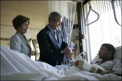 President George W. Bush and Mrs. Laura Bush talk with Sgt. Patrick Hagood of Anderson, S.C., Wednesday, Oct. 5, 2005, during their visit to Walter Reed Army Medical Center in Washington D.C.