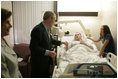 President George W. Bush shakes the hand of SPC Jeremy Goodman of Washington, N.C., as his wife, Terry Goodman, looks on Wednesday, Oct. 5, 2005, during a visit by the President and Mrs. Bush to Walter Reed Army Medical Center in Washington D.C.