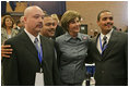 Laura Bush poses for photos with Homeboy Industries representatives, Gustavo Mojica, Herbert Corleto and Gabriel Hinojos, Thursday, Oct. 27, 2005 at Howard University in Washington, at the White House Conference on Helping America's Youth.