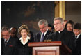 President George W. Bush and Laura Bush participate in a prayer led by Reverend Daniel Coughlin, House Chaplain, in honor of Rosa Parks during a wreath-laying ceremony in the Rotunda of the U.S. Capitol in Washington, D.C., Sunday Oct. 30, 2005. Rosa Parks passed away Monday, Oct. 24th.