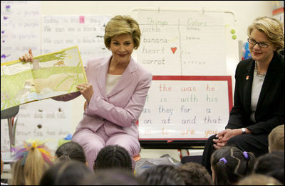 Laura Bush is joined by U.S. Education Secretary Margaret Spellings, right, as she reads a book to first graders at Lovejoy Elementary School in Des Moines, Iowa, Thursday, September 8, 2005.