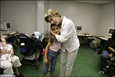 First Lady Laura Bush hugs a young girl displaced by Hurricane Katrina during her visit Friday, Sept. 2, 2005, to the Cajundome at the University of Louisiana in Lafayette. "Some things are working very, very well in Louisiana," Mrs. Bush said. "And certainly this center is one of those..."
