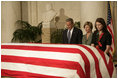 President George W. Bush and Laura Bush pay their respects to Chief Justice William Rehnquist as his body lies in repose in the Great Hall of the U.S. Supreme Court Tuesday, Sept. 6, 2005. Standing as honor guard for the Chief Justice is one of his former law clerks, Courtney Ellwood.