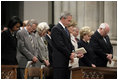 President George W. Bush bows his head in prayer during the National Day of Prayer and Remembrance Service at the Washington National Cathedral in Washington, D.C., Friday, Sept. 16, 2005. Also pictured are Laura Bush, Lynne Cheney Vice President Cheney, Secretary Rice and Secretary Rumsfeld.