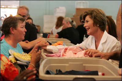 Laura Bush meets with people while visiting a clothing distribution site at the Biloxi Community Center, Tuesday, Sept. 27, 2005 in Biloxi, Miss., where she also interviewed with the television program, ABC's Extreme Makeover: Home Edition.