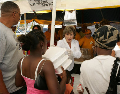 Laura Bush helps give out meals to families, while visiting a medical and food distribution site, Tuesday, Sept. 27, 2005 in Biloxi, Miss.