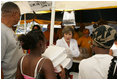 Laura Bush helps give out meals to families, while visiting a medical and food distribution site, Tuesday, Sept. 27, 2005 in Biloxi, Miss.