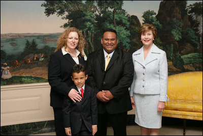 Mrs. Laura Bush poses for a photo with Sal Tinajero, his wife Jennifer and son Salvador, Thursday, April 6, 2006, in the Diplomatic Room at the White House. Mr. Tinajero, a high school teacher in Santa Ana, CA, is the recipient of Hispanic Magazine's Teacher of the Year award, which recognizes him as a single outstanding educator within the Hispanic community by means of motivating, inspiring and preparing his students for a promising future.