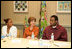 Mrs. Laura Bush listens to Jeremy Greathouse, an unemployed New Orleans youth, and LaToya Dorsha Williams, an Urban League participant, about difficulties of life experiences and employment during a discussion with the National Urban League in New Orleans, La., Monday, April 10, 2006. Urban League affiliate sites are providing youth care-focused employability skills, paid internships, and on-the job training to help participants enter full-time, private sector employment.