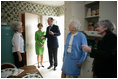 Gayle Dodson, Docent Coordinator, Left, and Dealey Herndon, Restoration/Historian greet Laura Bush, former President George H.W. Bush, and Mrs. Barbara Bush, Tuesday, April 11, 2006, at the beginning of their tour of George W. Bush Childhood Home in Midland, Texas.