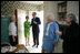 Gayle Dodson, Docent Coordinator, Left, and Dealey Herndon, Restoration/Historian greet Laura Bush, former President George H.W. Bush, and Mrs. Barbara Bush, Tuesday, April 11, 2006, at the beginning of their tour of George W. Bush Childhood Home in Midland, Texas.