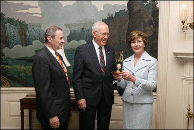 Victor Mooney, American Egg Board Chairman and Louis Raffel, American Egg Board President, present Mrs. Laura Bush with an annual commemorative egg from the American Egg Board Thursday, April 6, 2006 at the White House. The egg shell has been carved to display the Presidential Seal.