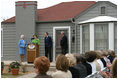 Mrs. Laura Bush, joined by former President George H.W. Bush, Mrs. Barbara Bush, and family friend, Joe O'Neill, speaks to the crowd on Tuesday, April 11, 2006, during a dedication and ribbon cutting ceremony for the opening of President George W. Bush’s Childhood Home in Midland, Texas.