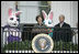 Mrs. Laura Bush and President George W. Bush welcome guests to the 2006 White House Easter Egg Roll, Monday, April 17, 2006, a tradition on the South Lawn of the White House since 1878.