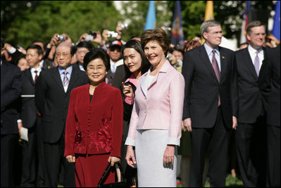 Mrs. Laura Bush stands with Liu Yongqing, the wife of Chinese President Hu Jintao, during the South Lawn Arrival Ceremony, Thursday, April 20, 2006.