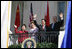 President George W. Bush, Chinese President Hu Jintao, Laura Bush and Hu's wife, Liu Yongqing, wave from the South Portico balcony after the South Lawn Arrival Ceremony at the White House, Thursday, April 20, 2006.