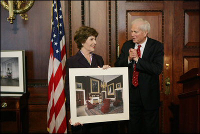Mrs. Laura Bush is presented with a print by Dr. James Billington, the Librarian of Congress, showing an interior view of the White House as it looked in the early 1900s, Wednesday, April 26, 2006 during the James Madison Council Luncheon at the Library of Congress.