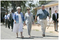 Mrs. Laura Bush meets with Biloxi, Miss., residents Sandy Patterson, left, and her husband, Thomas "Lynn" Patterson Monday, Aug. 28, 2006, during a walking tour in the same Biloxi neighborhood President George W. Bush visited following Hurricane Katrina in September 2005. The tour allowed President Bush the opportunity to assess the progress of the area's recovery and rebuilding efforts a year after the devastating hurricane.