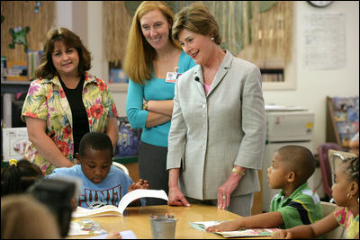 Mrs. Laura Bush meets and speaks with members of the Gorenflo Elementary School first grade class and their faculty Monday, Aug. 28, 2006, at their temporary portable classroom at the Beauvoir Elementary School in Biloxi, Miss. The students, whose school was damaged by Hurricane Katrina, are sharing the facilities of the Beauvoir school until their school's renovations are complete.